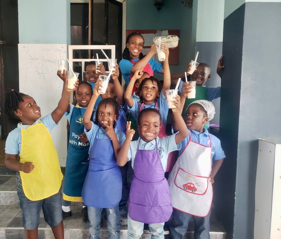 Teacher and students in aprons celebrating their smoothies