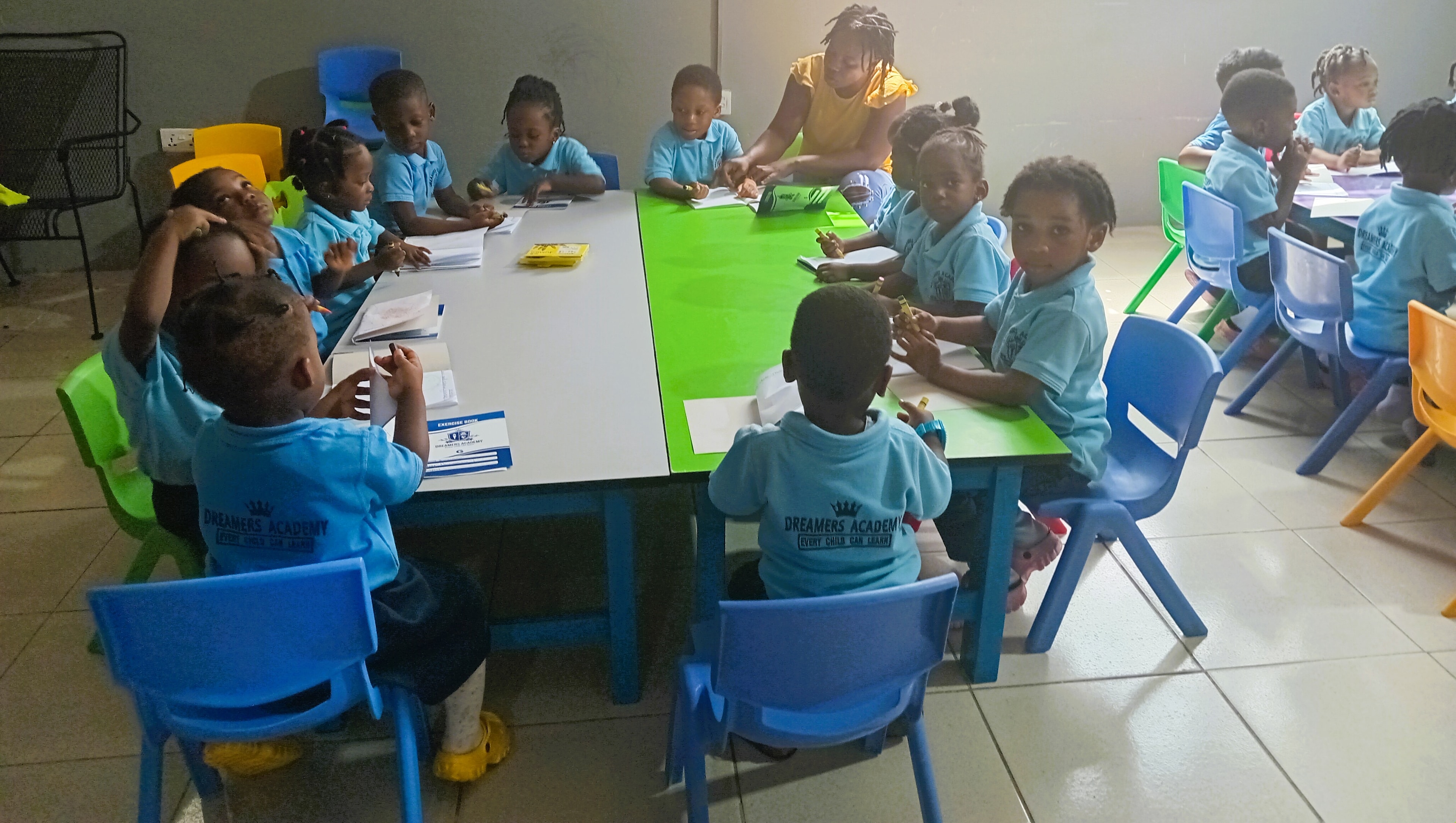 Teacher helping students at their desks