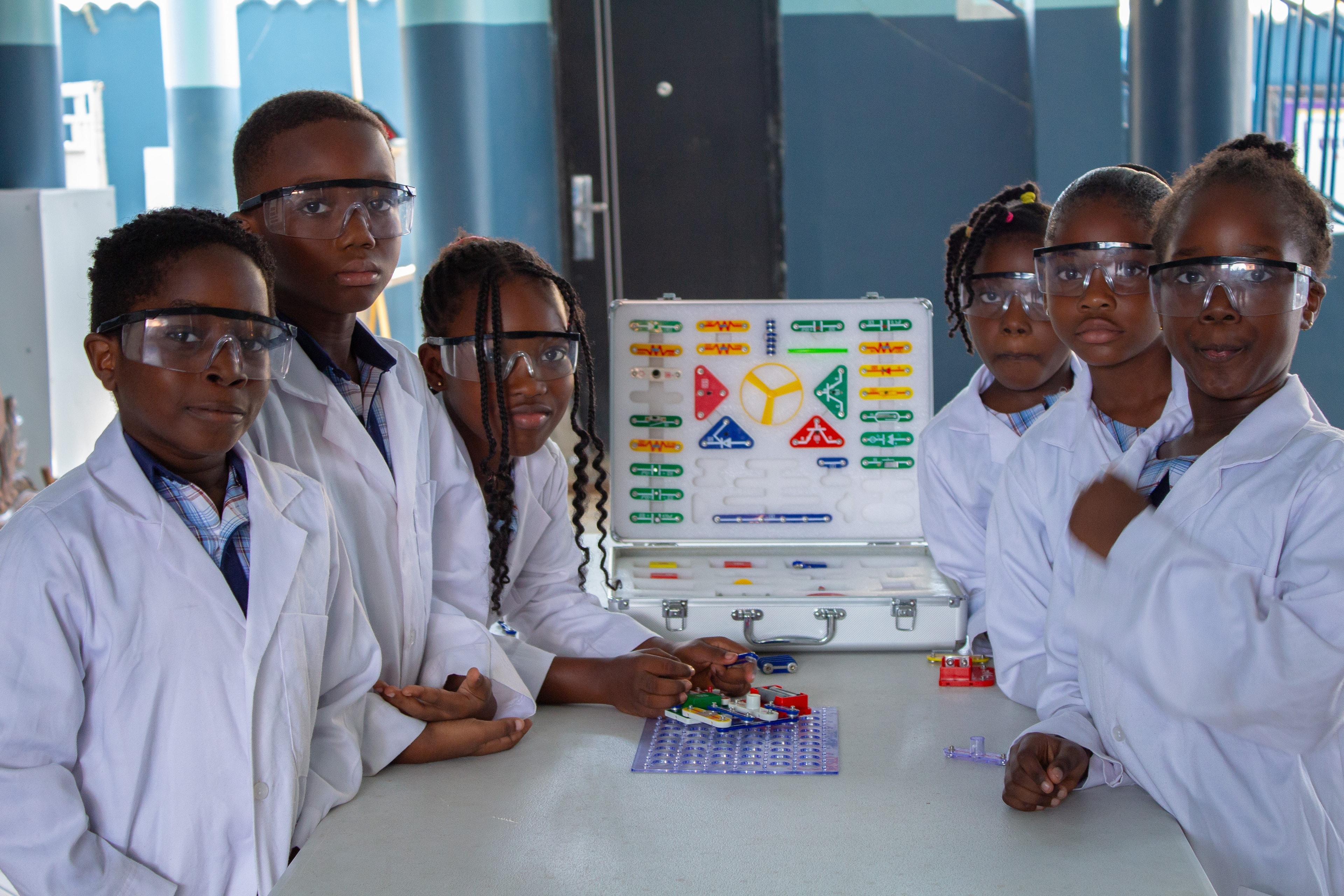 Dreamers Academy-GH students in lab coats with engineering kits